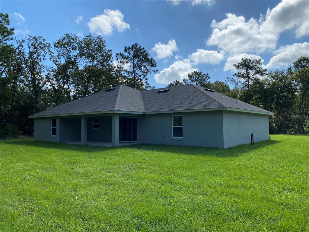 16090 Southwest 55th Avenue Road Ocala, FL 34473 - Photo 27 of 28 a view of a house with a yard and a yard
