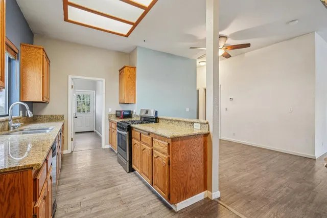 a kitchen with stainless steel appliances granite countertop a stove and a sink