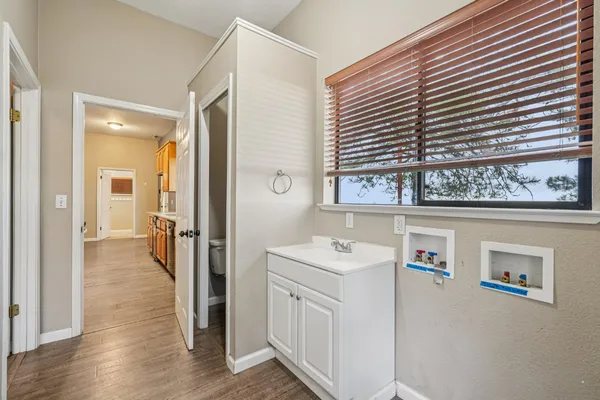 a bathroom with a sink a vanity and a window