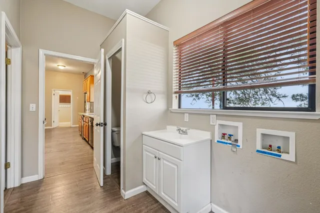 a bathroom with a sink a vanity and a window