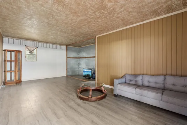 a living room with furniture and a floor to ceiling window