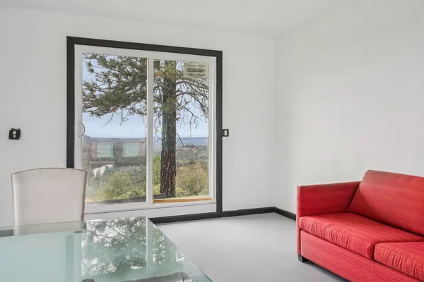 a dining room with furniture and a window