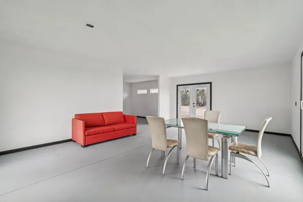 a view of a kitchen with wooden floor and a ceiling fan