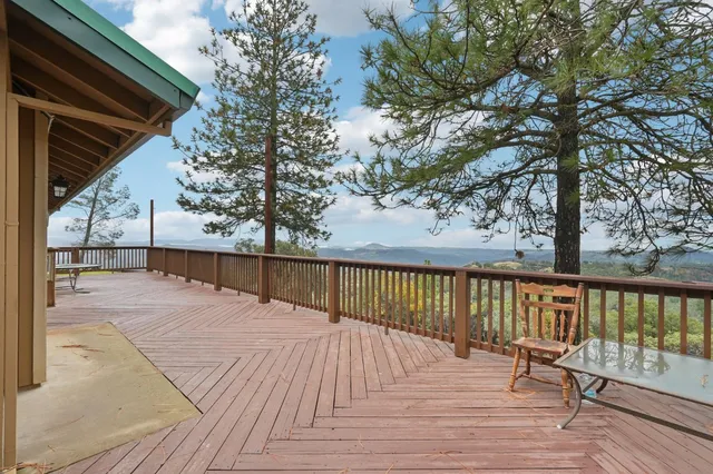 a view of a house with a wooden deck
