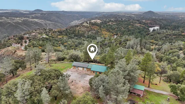 an aerial view of a house with a yard