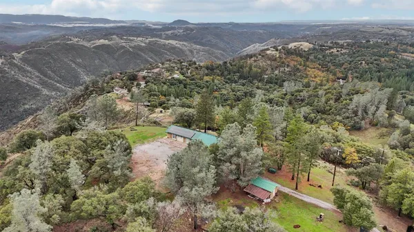an aerial view of a house with a yard