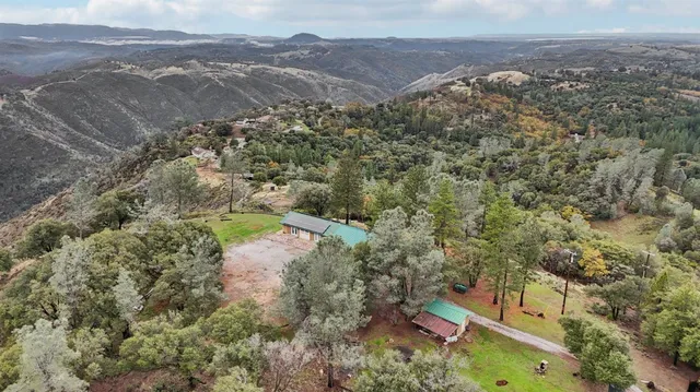 an aerial view of a house with a yard