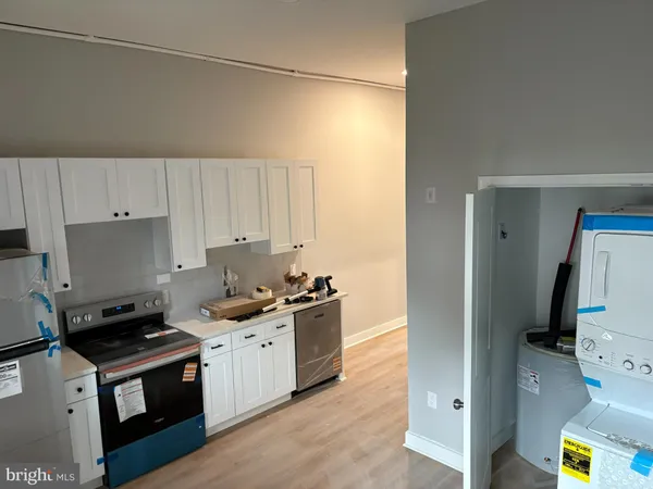 a kitchen with a stove a sink and a refrigerator