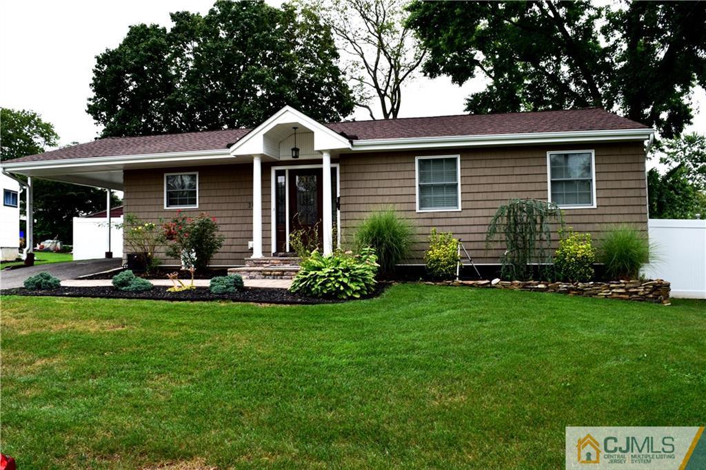10 Fordham Road Old Bridge, NJ 08859 - Photo 1 of 26 a front view of a house with a garden and patio