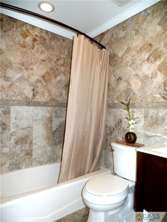 10 Fordham Road Old Bridge, NJ 08859 - Photo 11 of 26 a white toilet sitting next to a bath tub and a shower curtain