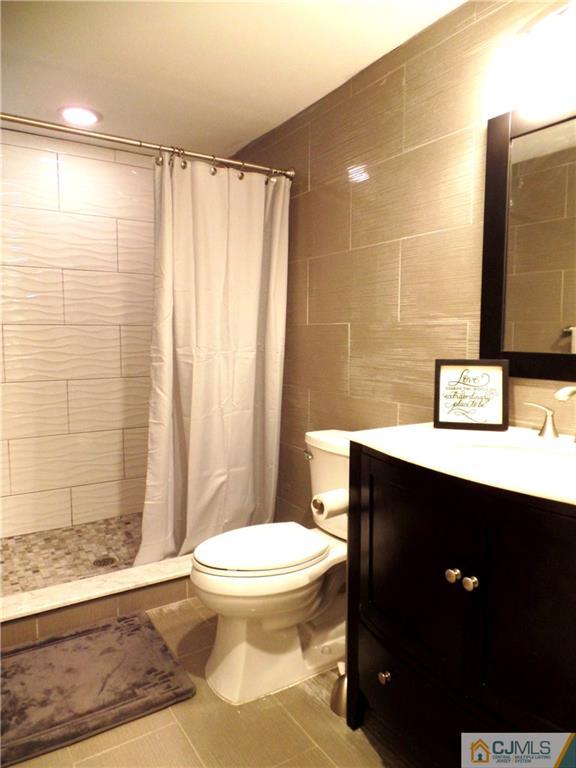 10 Fordham Road Old Bridge, NJ 08859 - Photo 17 of 26 a bathroom with a toilet a sink and shower