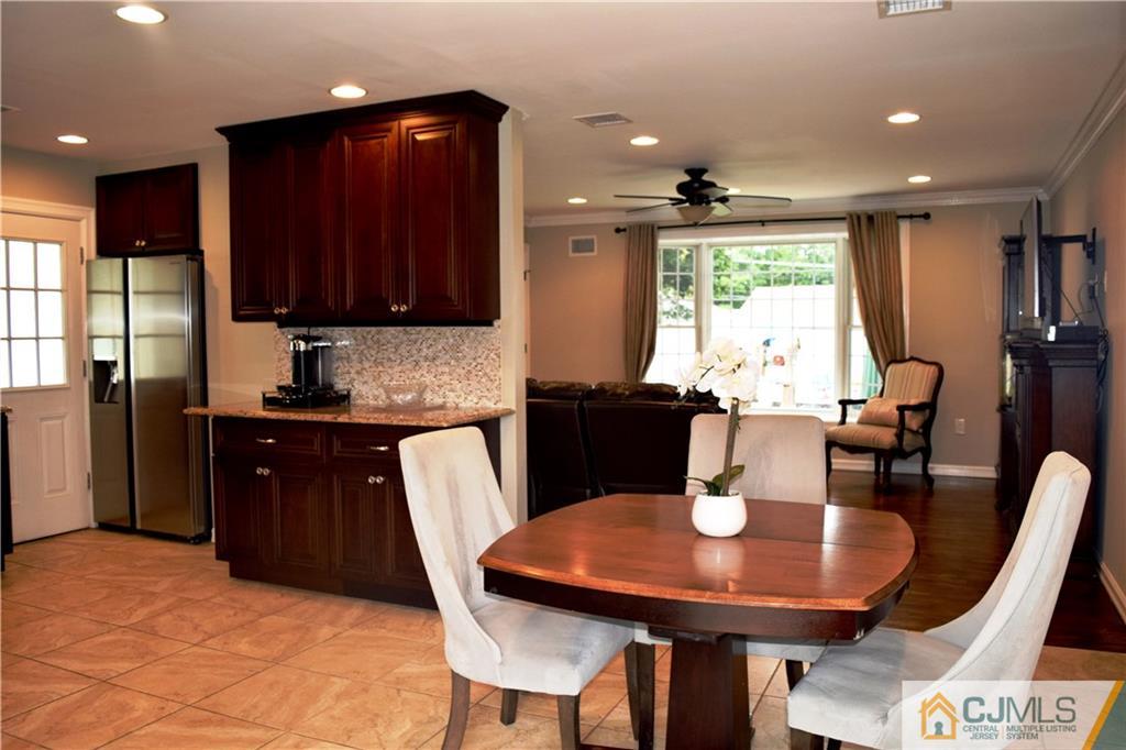 10 Fordham Road Old Bridge, NJ 08859 - Photo 3 of 26 a kitchen with stainless steel appliances granite countertop a table chairs and a refrigerator