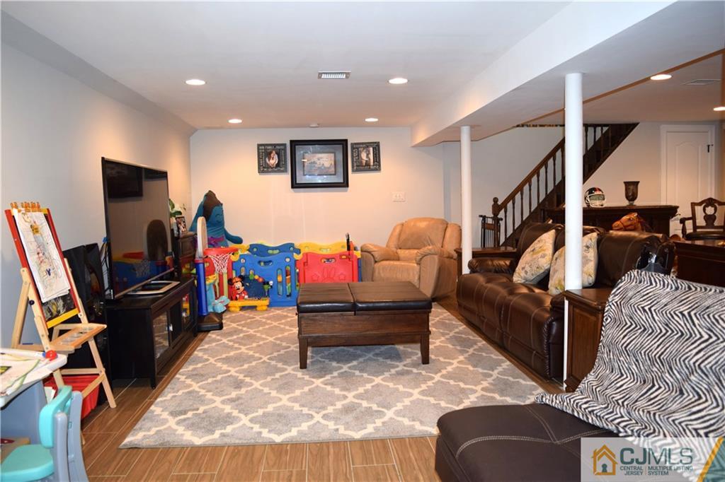 10 Fordham Road Old Bridge, NJ 08859 - Photo 21 of 26 a living room with furniture and a flat screen tv