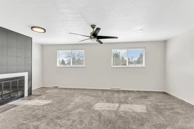 a view of room with projector and fireplace