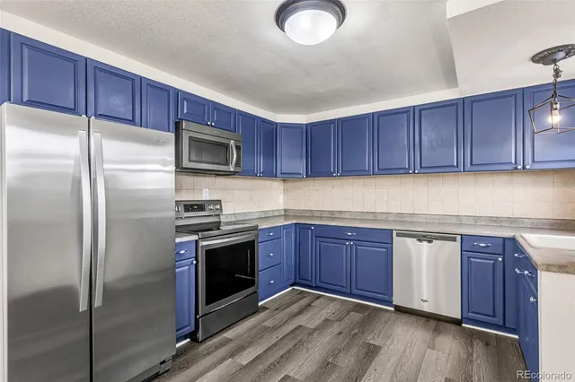 a kitchen with stainless steel appliances granite countertop a stove microwave and refrigerator