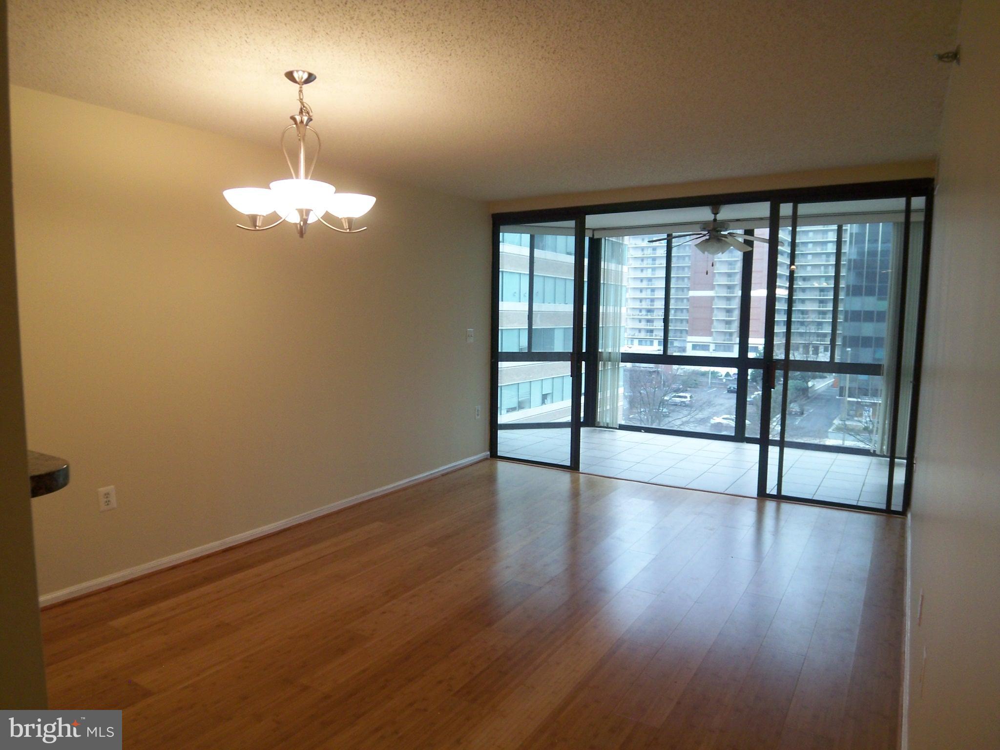 1001 North Randolph Street, Unit 516 Arlington, VA 22201 - Photo 11 of 18 wooden floor in an empty room with a window