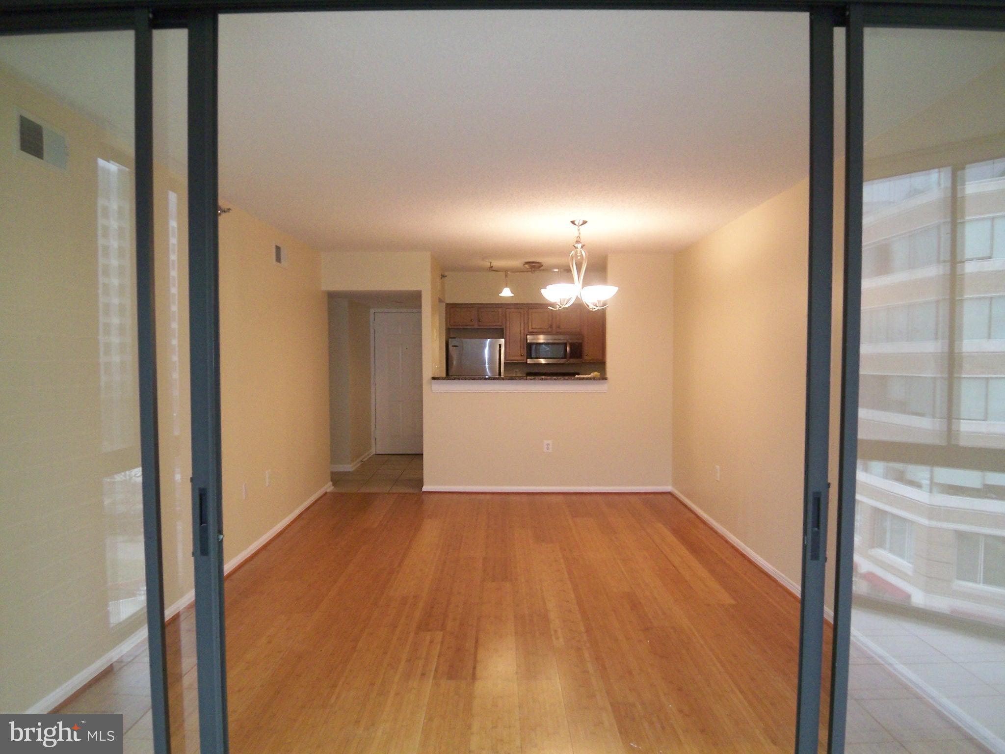1001 North Randolph Street, Unit 516 Arlington, VA 22201 - Photo 12 of 18 a view of a hallway with wooden floor
