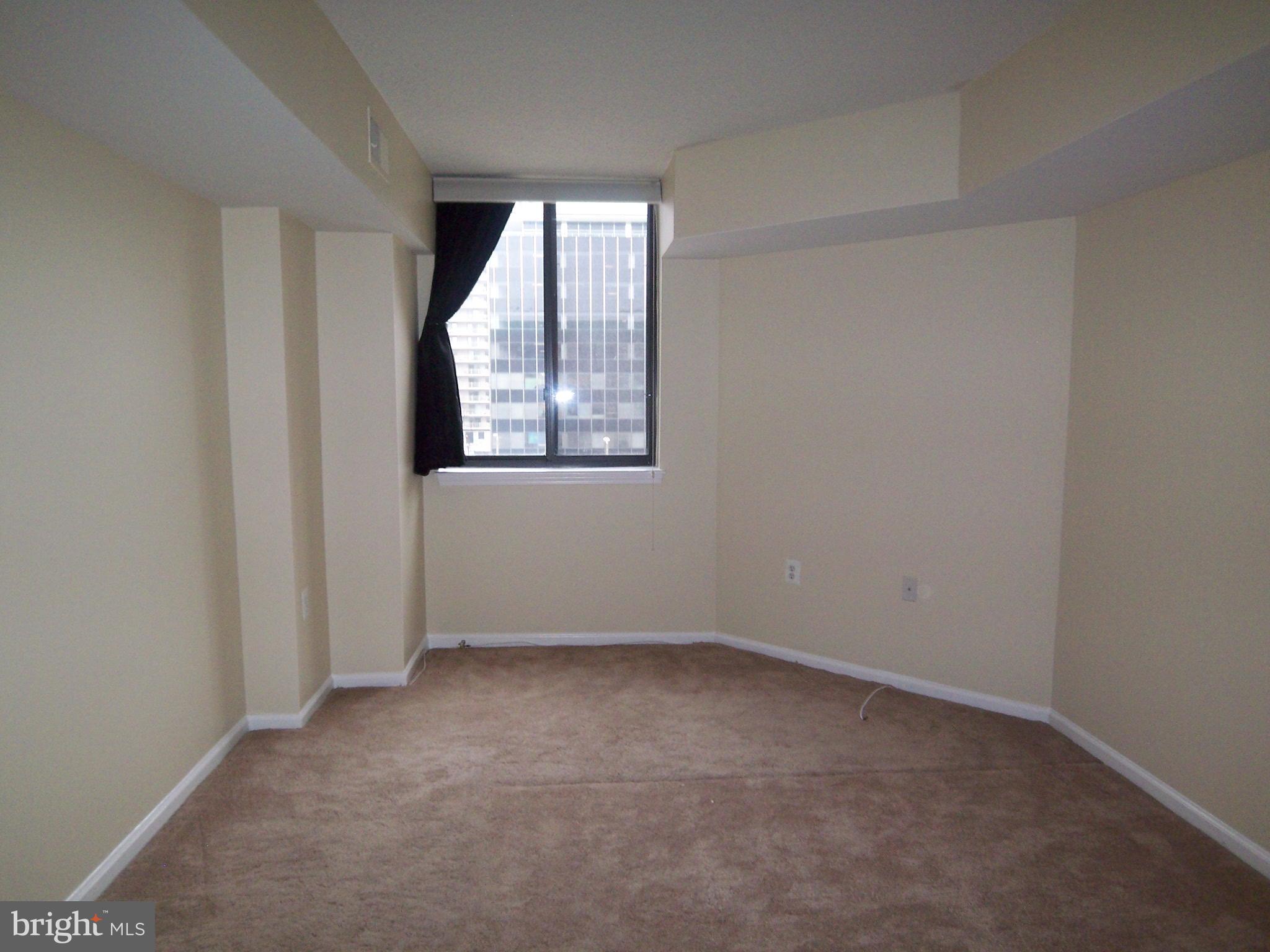 1001 North Randolph Street, Unit 516 Arlington, VA 22201 - Photo 14 of 18 an empty room with windows