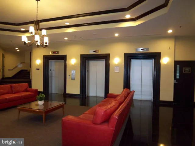 a living room with furniture a ceiling fan and a window