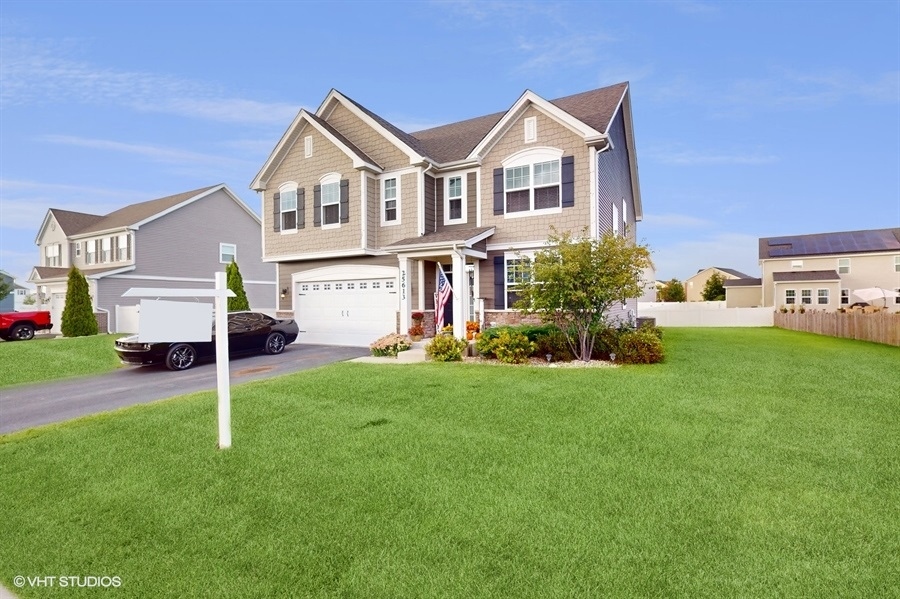a view of a house with a yard and sitting area