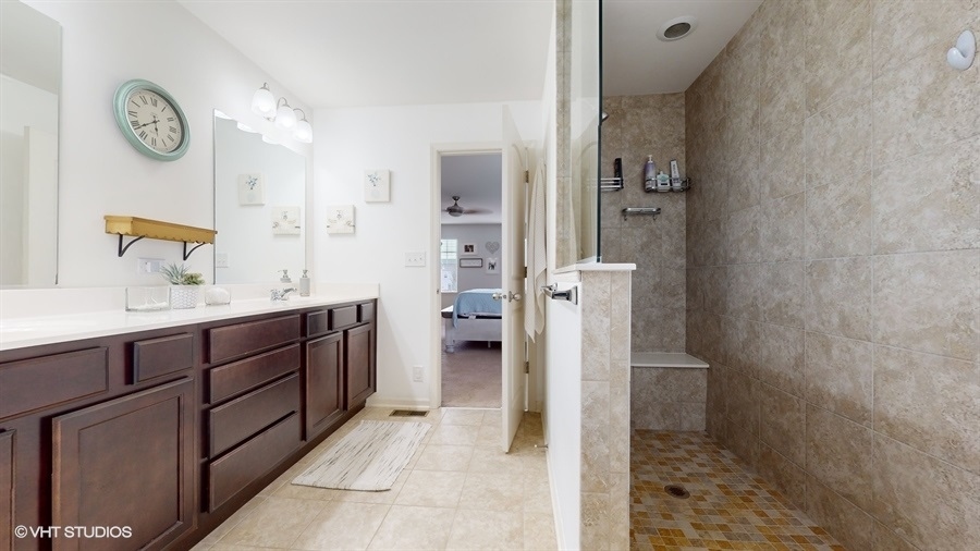 25613 West Cerena Circle Plainfield, IL 60586 - Photo 12 of 28 a spacious bathroom with a sink a mirror and a shower
