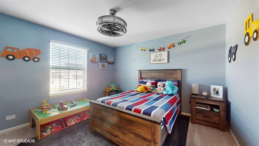 25613 West Cerena Circle Plainfield, IL 60586 - Photo 16 of 28 a room that has a bed and a table in it