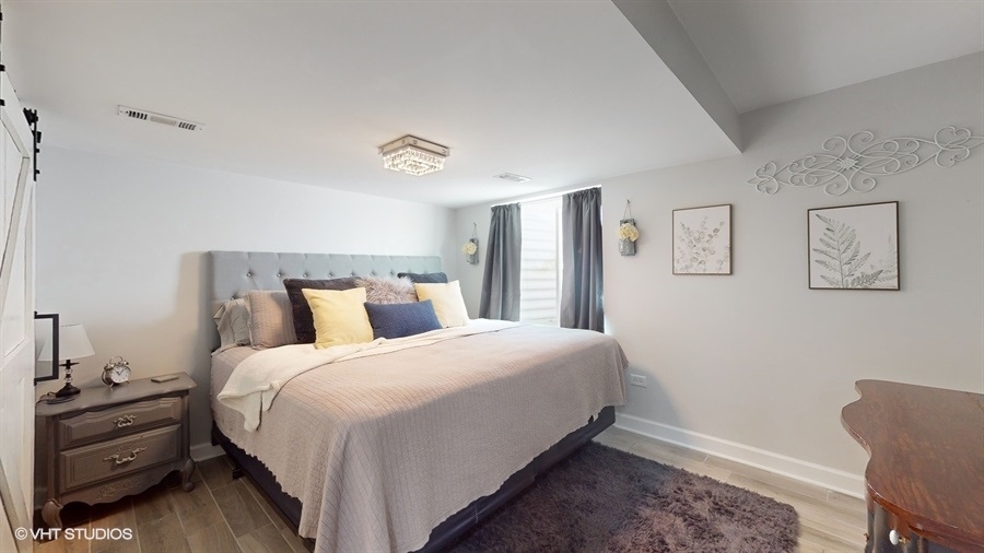 25613 West Cerena Circle Plainfield, IL 60586 - Photo 23 of 28 a bedroom with a bed and a chair