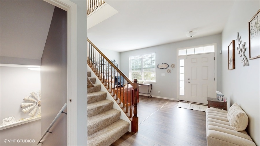 25613 West Cerena Circle Plainfield, IL 60586 - Photo 6 of 28 a view of a livingroom with wooden floor and stairs