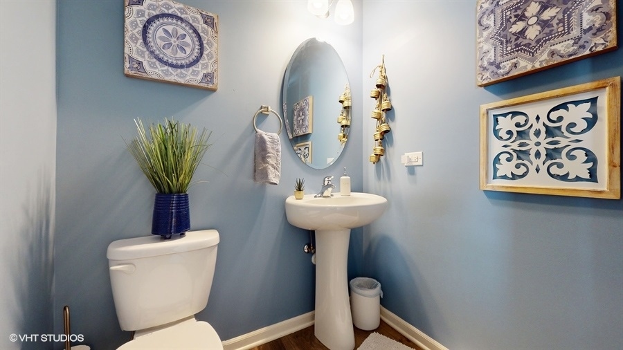 25613 West Cerena Circle Plainfield, IL 60586 - Photo 8 of 28 a bathroom with a toilet sink and mirror