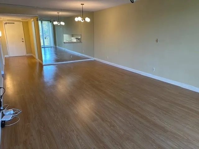 a view of a room with wooden floor