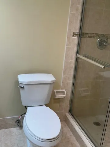 a white toilet sitting next to a sink
