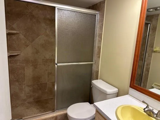 a white toilet sitting next to a bathroom sink