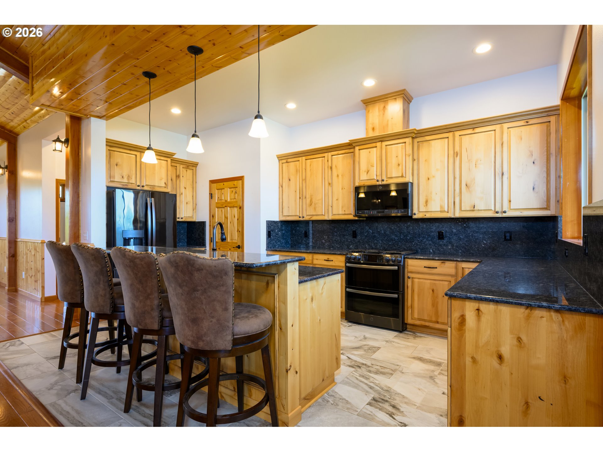 1757 Riddle Bypass Road Riddle, OR 97469 - Photo 16 of 48 a kitchen with stainless steel appliances granite countertop table chairs and a refrigerator