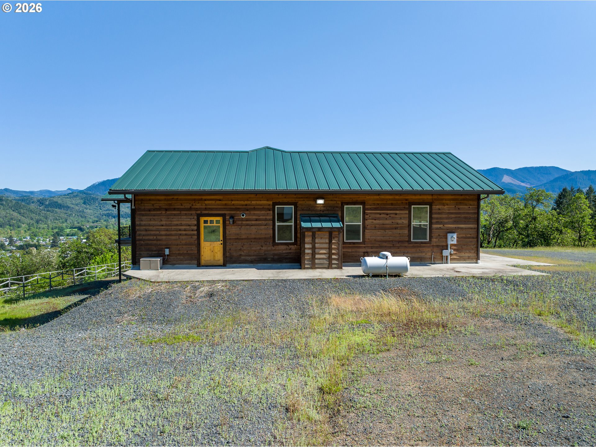 1757 Riddle Bypass Road Riddle, OR 97469 - Photo 5 of 48 a front view of a house with a yard and garage