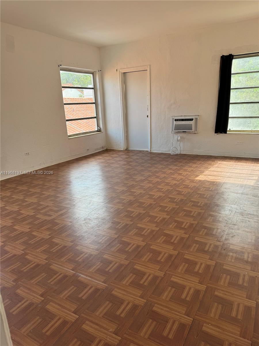825 Alton Road, Unit 8 Miami Beach, FL 33139 - Photo 6 of 11 an empty room with windows and closet