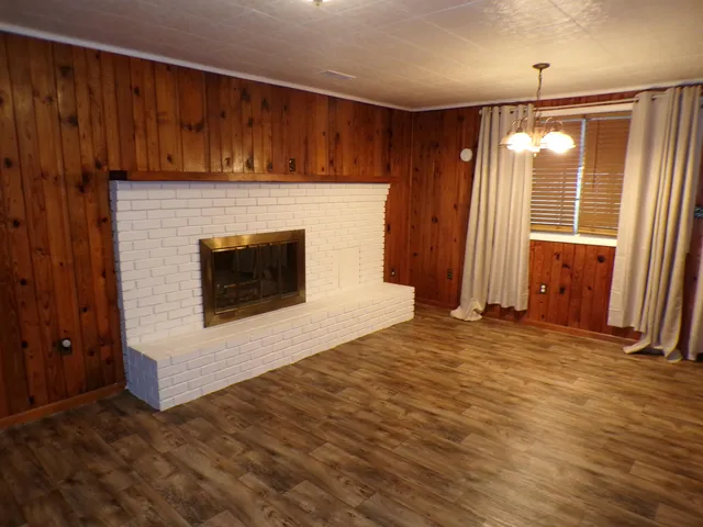 a view of an empty room with a fireplace