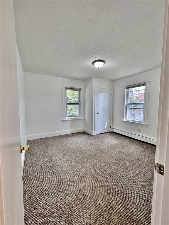 90 Brook Road, Unit 1R Quincy, MA 02169 - Photo 5 of 5 an empty room with windows