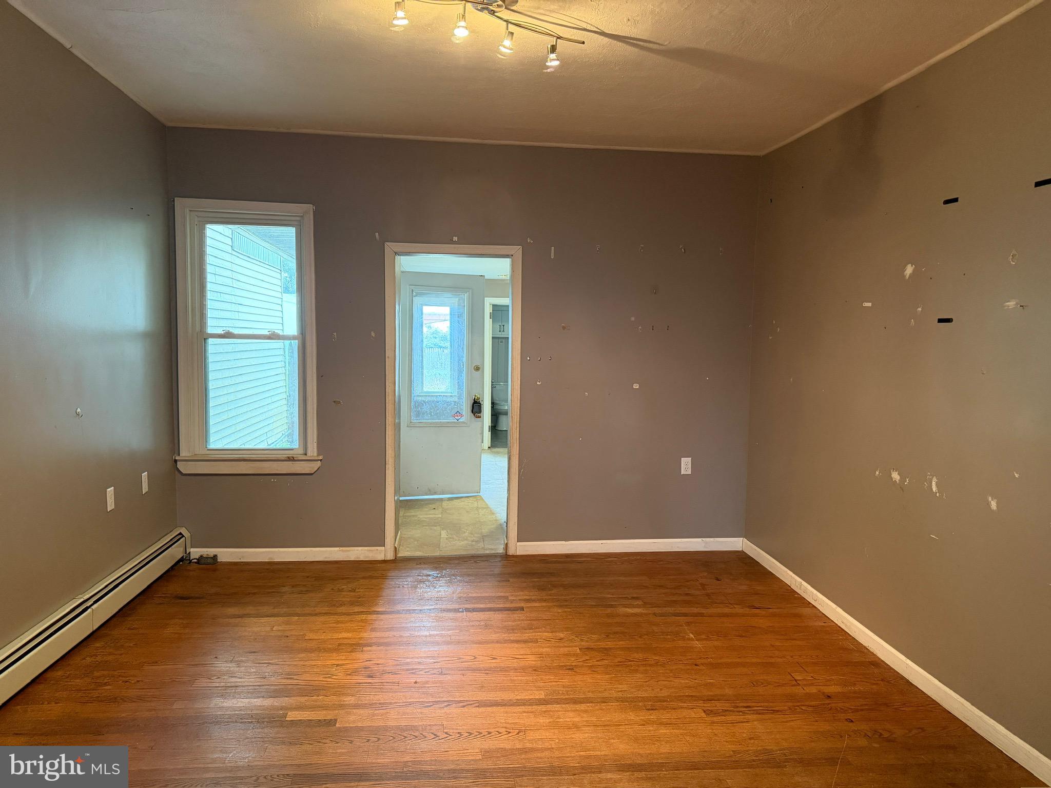 125 South Main Street Manheim, PA 17545 - Photo 12 of 27 an empty room with wooden floor and windows