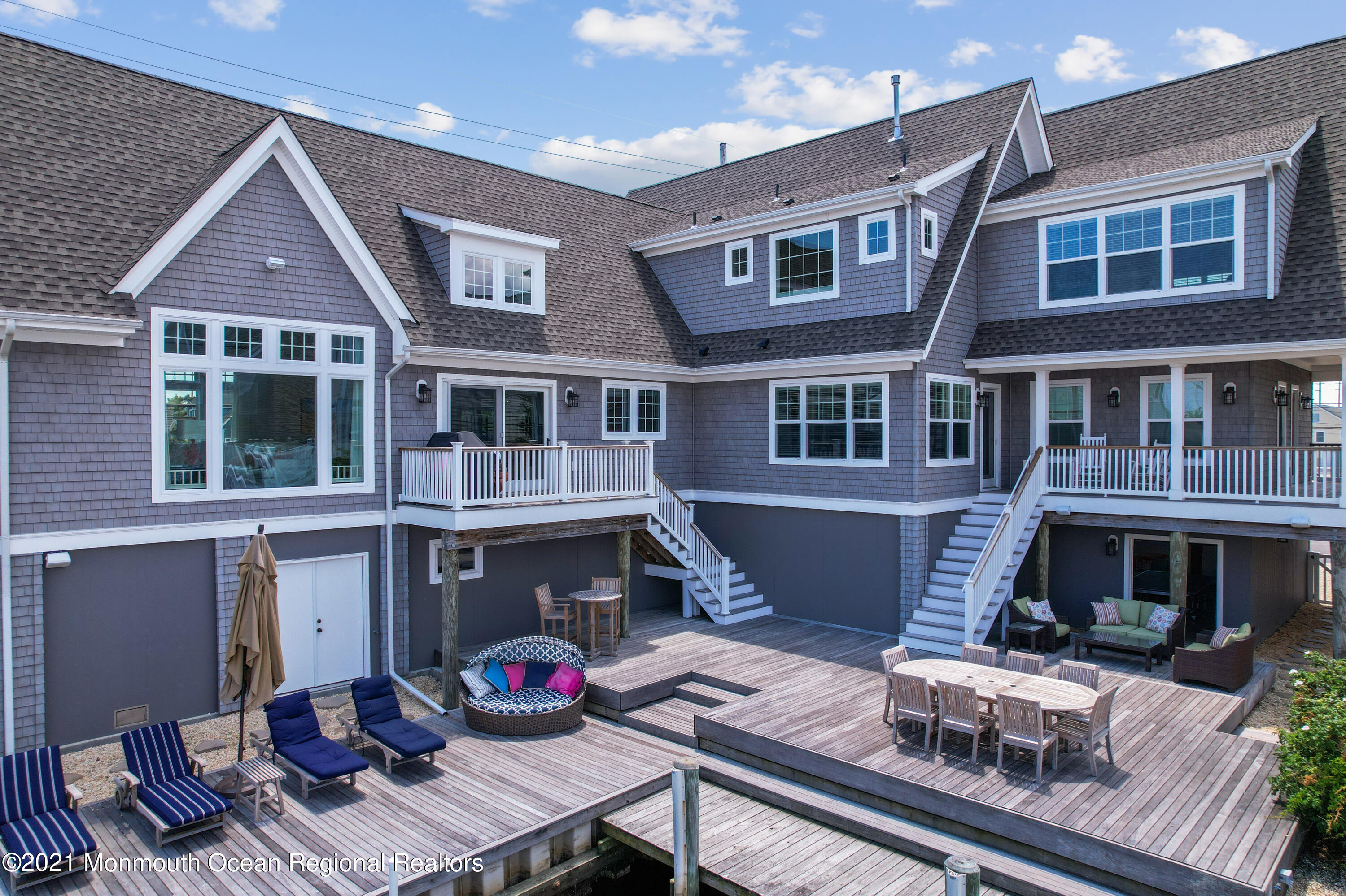 a front view of residential houses with outdoor seating