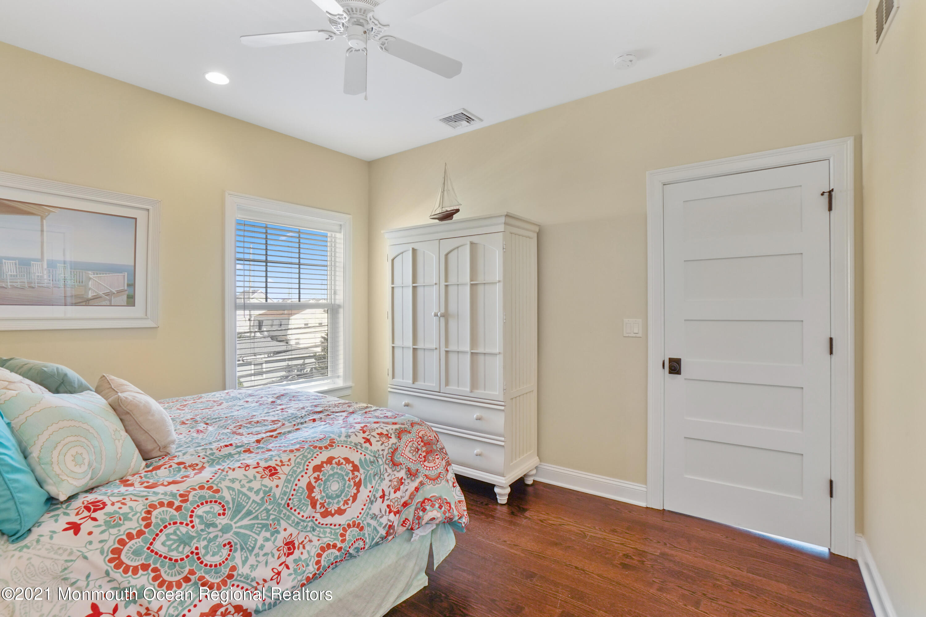 204 North Lagoon Road Lavallette, NJ 08735 - Photo 26 of 44 a bedroom with a bed and a chandelier