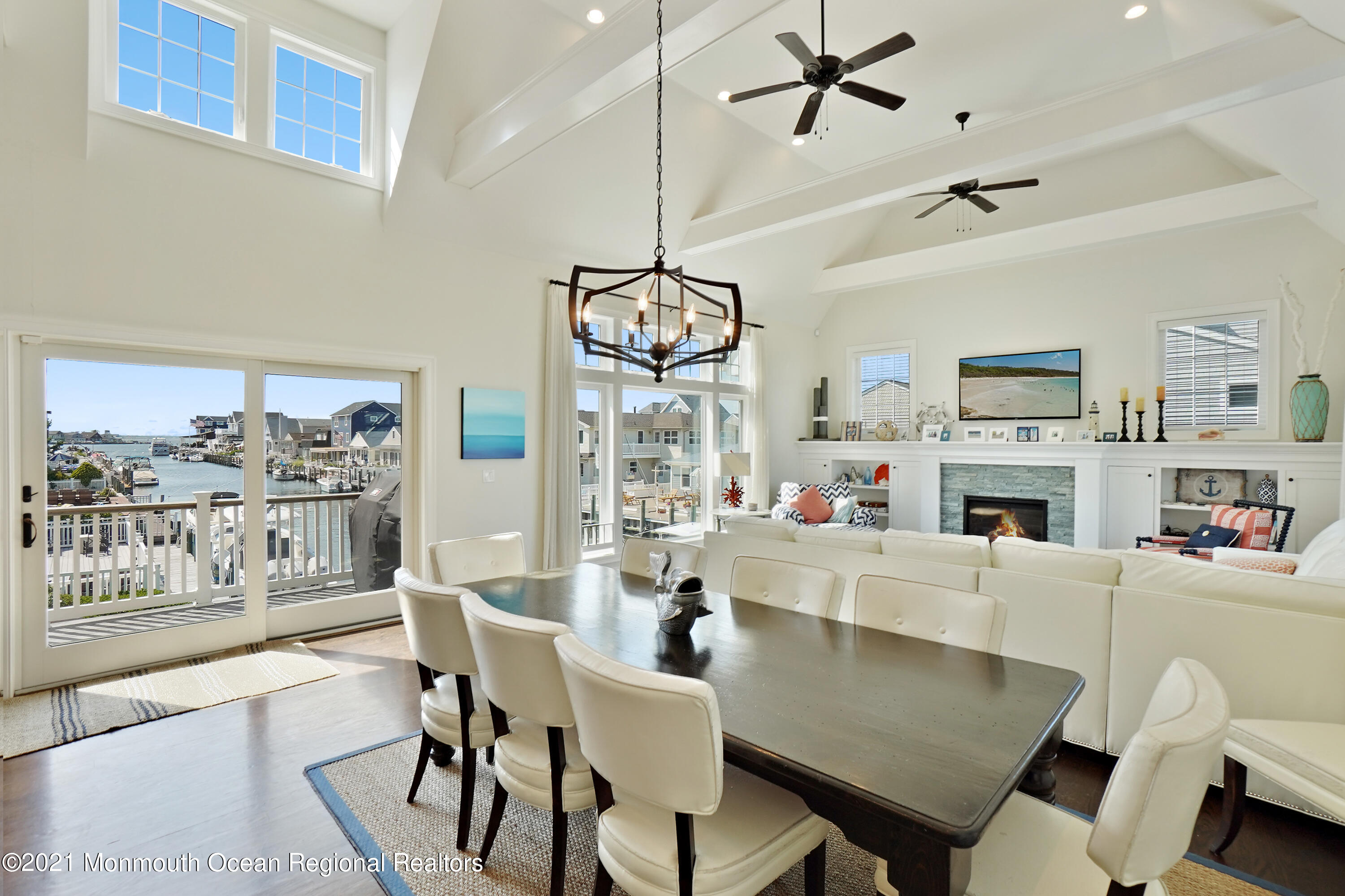 204 North Lagoon Road Lavallette, NJ 08735 - Photo 4 of 44 a dining room with wooden floor a chandelier a glass table and chairs