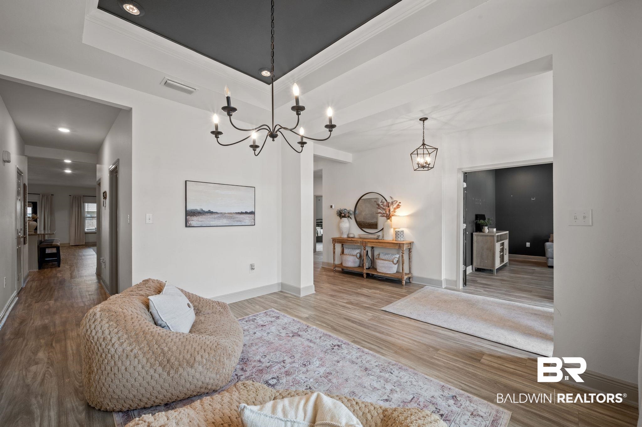 10169 Dunleith Loop Daphne, AL 36526 - Photo 21 of 40 Living area featuring a chandelier, wood finished floors, ornamental molding, a tray ceiling, and recessed lighting