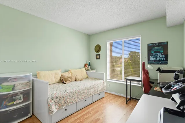 a bedroom with a bed and a desk