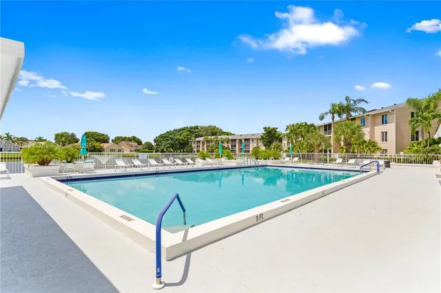 a view of swimming pool with outdoor seating and plants
