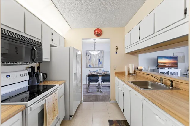 a kitchen with granite countertop a sink and appliances