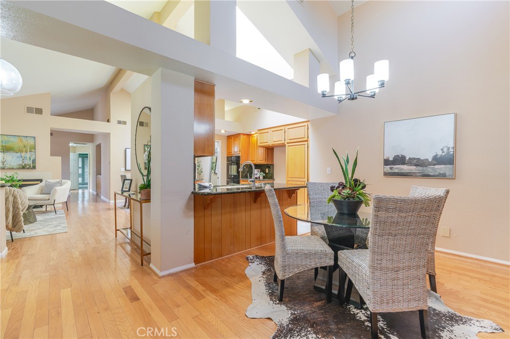 1049 Fairview Avenue, Unit 5 Arcadia, CA 91007 - Photo 11 of 26 a view of a dining room with furniture a chandelier and wooden floor