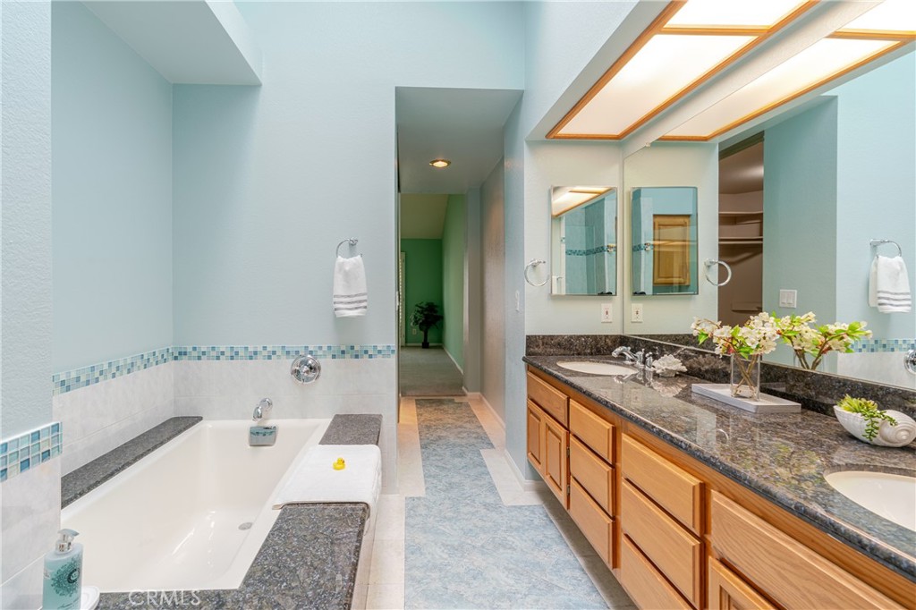 1049 Fairview Avenue, Unit 5 Arcadia, CA 91007 - Photo 16 of 26 a bathroom with a tub a sink and a large mirror