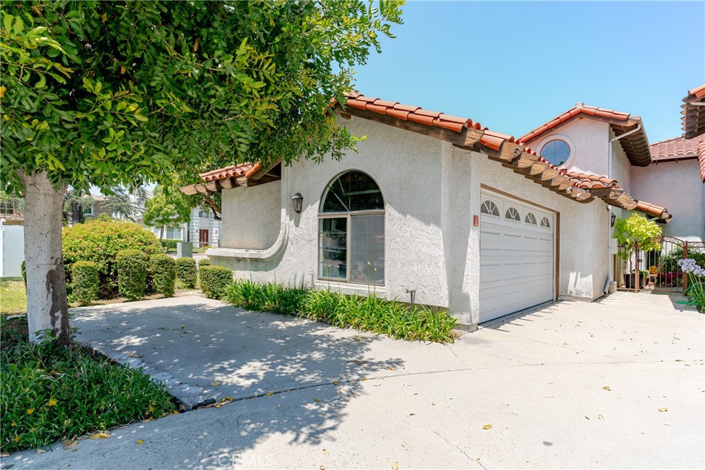 1049 Fairview Avenue, Unit 5 Arcadia, CA 91007 - Photo 23 of 26 a front view of a house with a yard and garage