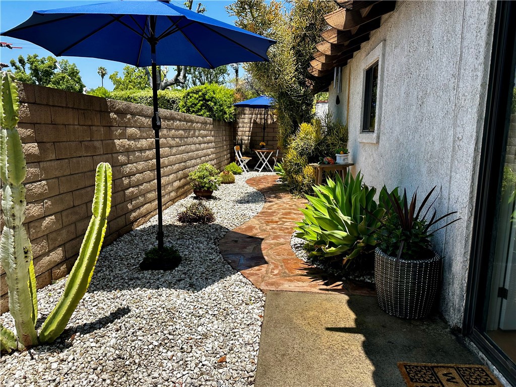 1049 Fairview Avenue, Unit 5 Arcadia, CA 91007 - Photo 24 of 26 a view of a backyard with chairs under an umbrella