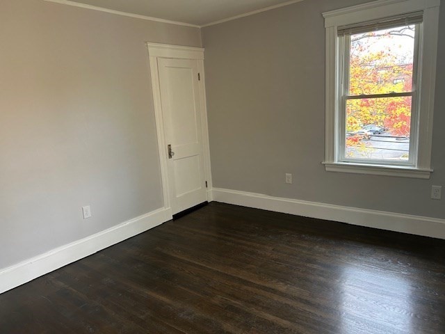 84 Aberdeen Avenue, Unit 1 Cambridge, MA 02138 - Photo 16 of 17 an empty room with wooden floor and windows